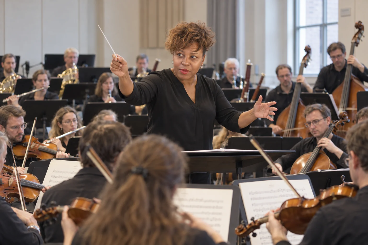 Unathi conducting a symphony orchestra